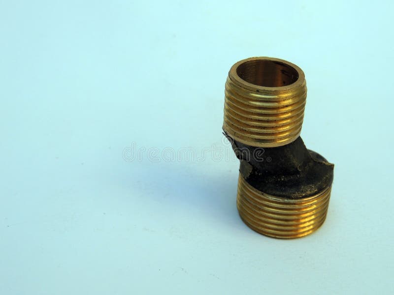 Plumbing adapter from half an inch to three quarters of an inch made of brass isolated on white background. Plumbing adapter from half an inch to three quarters of an inch made of brass isolated on white background