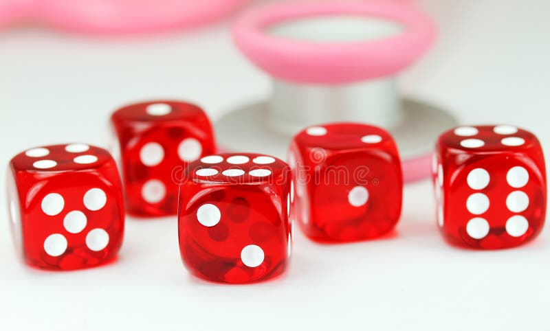 A Doctors pink colored stethoscope with five red dice resting in front of it, asking the question do you gamble with your health. A Doctors pink colored stethoscope with five red dice resting in front of it, asking the question do you gamble with your health.