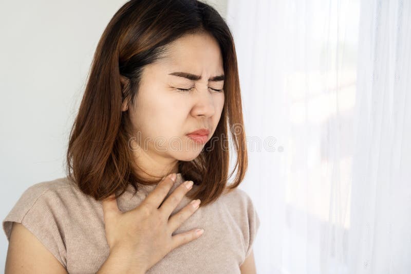 Asian woman suffering from nausea and vomiting, foodborne illness concept. Asian woman suffering from nausea and vomiting, foodborne illness concept