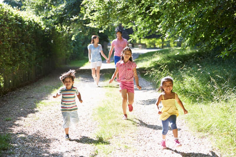 Happy Asian Family Enjoying Walk In Countryside. Happy Asian Family Enjoying Walk In Countryside