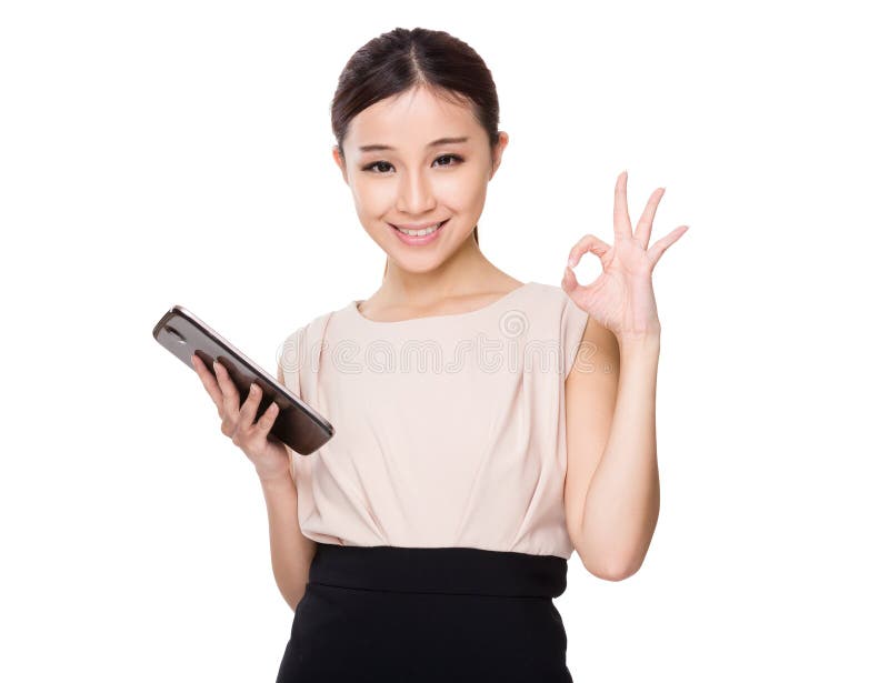 Asian woman hold with tablet and ok sign gesture isolated on white background. Asian woman hold with tablet and ok sign gesture isolated on white background