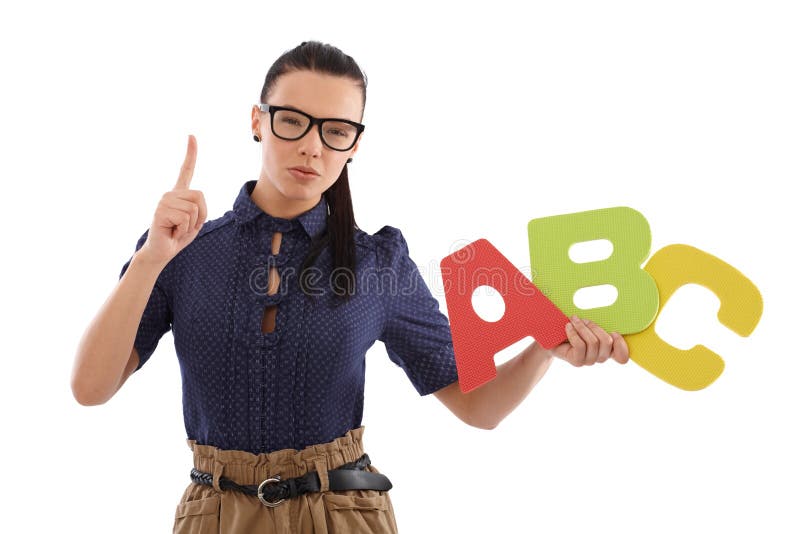 Strict schoolmistress teaching alphabet by holding capital letters in hand. Strict schoolmistress teaching alphabet by holding capital letters in hand.