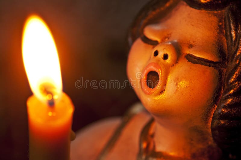 Closeup of a singing angel with candle. Closeup of a singing angel with candle