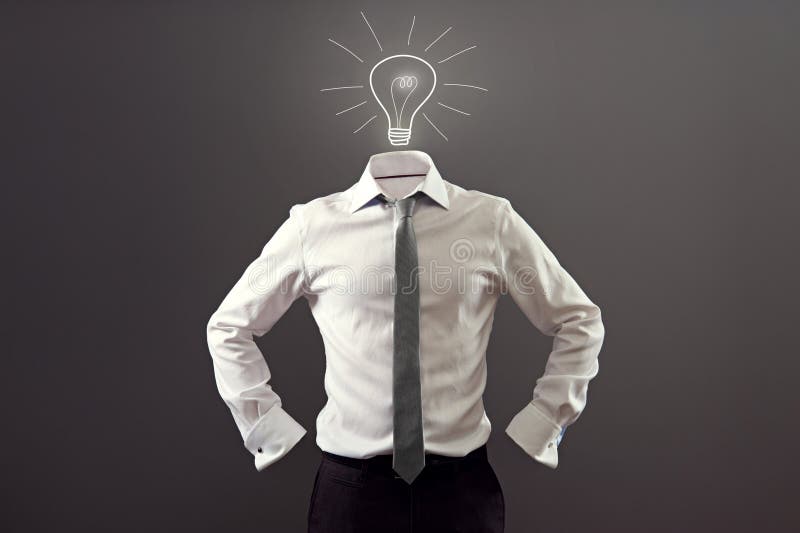 Anonymous man in white shirt and black trousers having an idea over dark background. Anonymous man in white shirt and black trousers having an idea over dark background