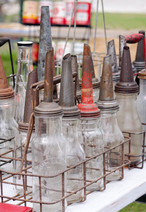 Antique oil containers were made at one time out of glass. these are on display, and for sale at an outdoor antique shop. Antique oil containers were made at one time out of glass. these are on display, and for sale at an outdoor antique shop