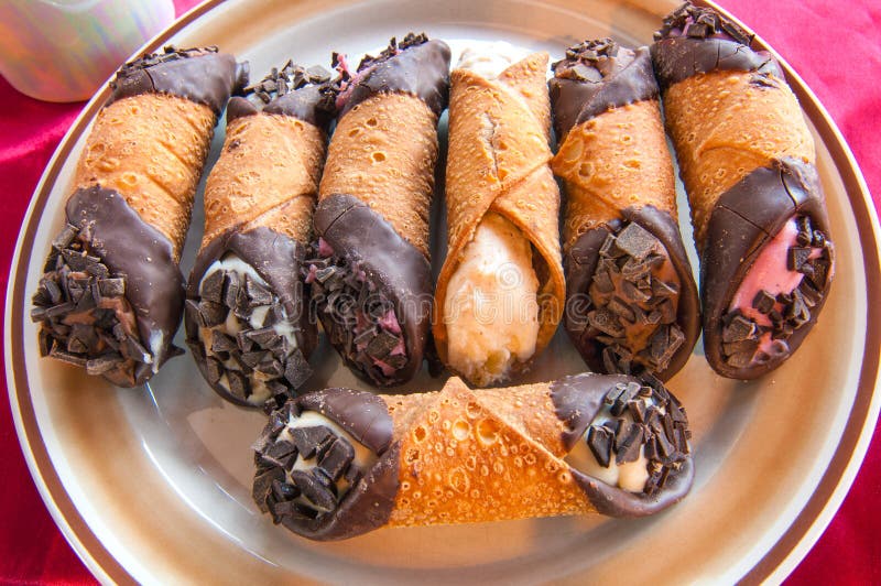 A variety of cannoli with fillings of different flavors and colors. A variety of cannoli with fillings of different flavors and colors