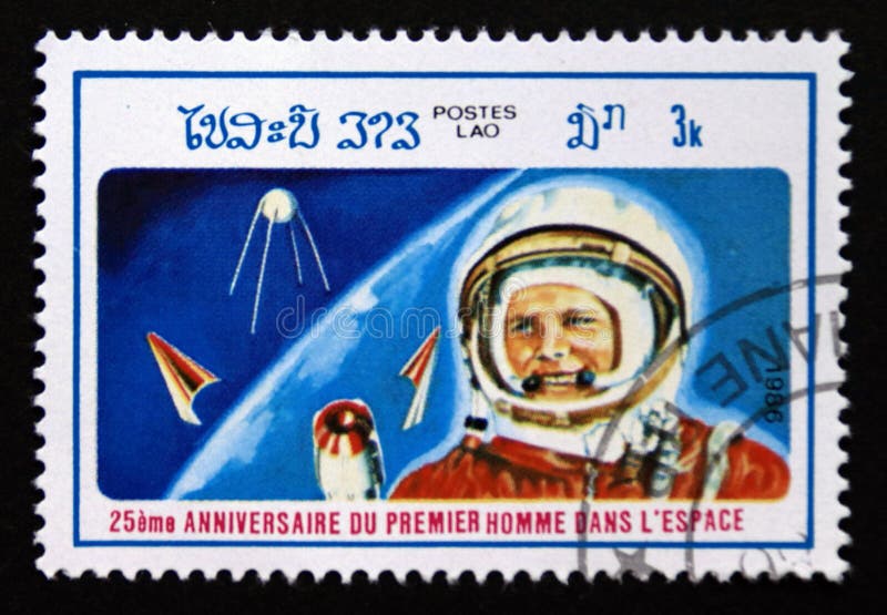 Post stamp printed in Laos, 1986. Astronaut yuri gagarin, sputnik 1. Value 3 lao kip. From the series 25th anniversary.of first man in space. Post stamp printed in Laos, 1986. Astronaut yuri gagarin, sputnik 1. Value 3 lao kip. From the series 25th anniversary.of first man in space.