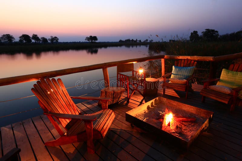 Enjoy a refreshing sundowner in cozy ambiance at the bank of smooth Kwando River in the Caprivi Strip, Namibia. Enjoy a refreshing sundowner in cozy ambiance at the bank of smooth Kwando River in the Caprivi Strip, Namibia.