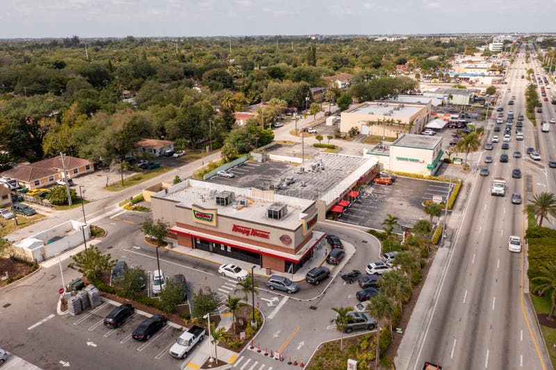 Miami, FL, USA - April 30, 2021: Aerial drone photo Krispy Kreme donut shop North Miami 163rd Street. Miami, FL, USA - April 30, 2021: Aerial drone photo Krispy Kreme donut shop North Miami 163rd Street