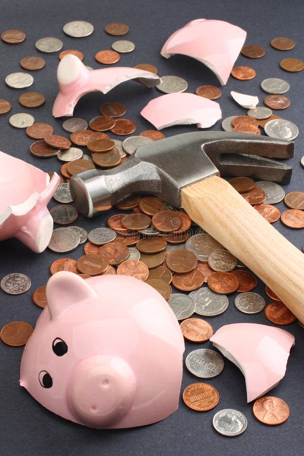 Financial savings concept featuring a piggy bank broken by hammer loaded with money. Business & Finance Collection. Financial savings concept featuring a piggy bank broken by hammer loaded with money. Business & Finance Collection.