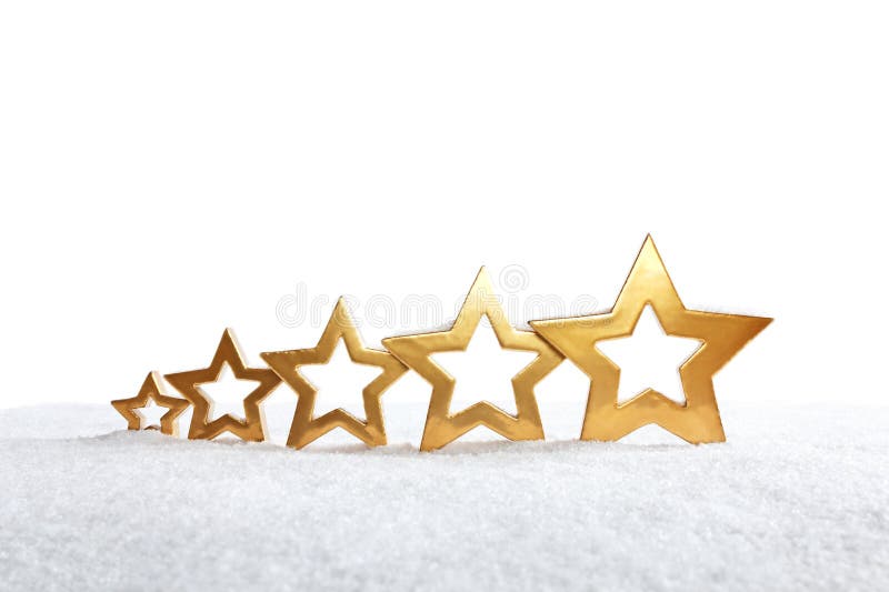 Five rising golden stars on snow on white, background, copy or text space. Five rising golden stars on snow on white, background, copy or text space