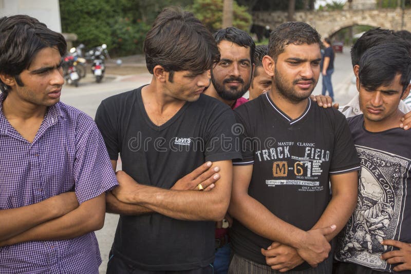 KOS, GREECE - SEP 27, 2015: Unidentified refugees. More than half are migrants from Syria, but there are refugees from other countries - Afghanistan, Pakistan, Iraq, Iran, Mali, Bangladesh, Eritrea. KOS, GREECE - SEP 27, 2015: Unidentified refugees. More than half are migrants from Syria, but there are refugees from other countries - Afghanistan, Pakistan, Iraq, Iran, Mali, Bangladesh, Eritrea.