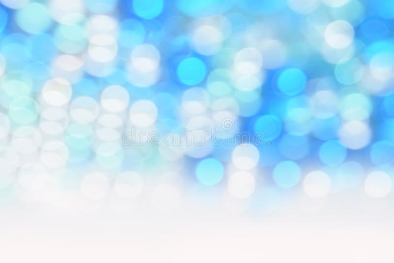 Белизна блестящего bokeh круговая на голубой предпосылке и пустой космос для текста стоковые изображения rf Белизна блестящего bokeh круговая на голубой предпосылке и пустой космос для текста стоковые изображения rf