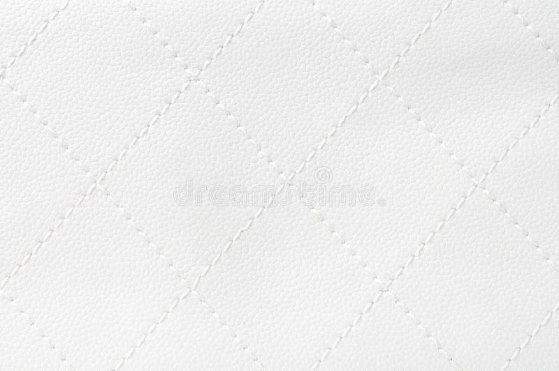 White quilted leather background close up. White quilted leather background close up