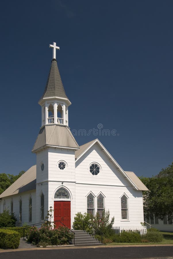 Classic white church with bright red doors. Classic white church with bright red doors.