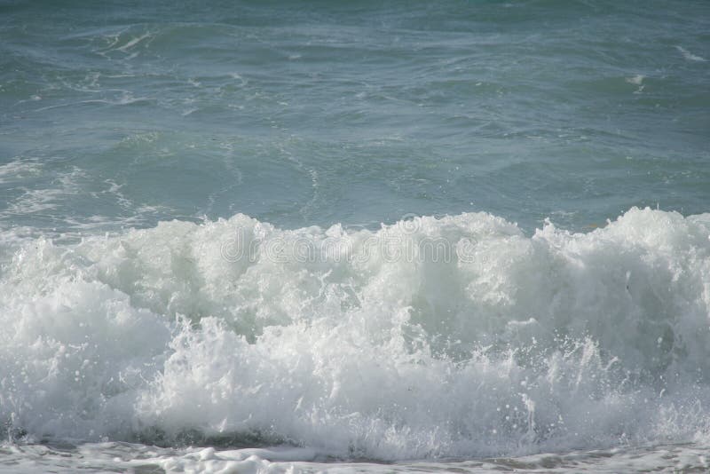 White foam waves erase with each wave, photos taken on the beach 1 sunny day. White foam waves erase with each wave, photos taken on the beach 1 sunny day