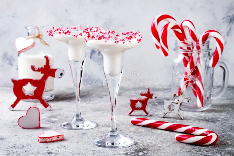 White chocolate peppermint martini with candy cane rim. Christmas holiday party drink idea. White chocolate peppermint martini with candy cane rim. Christmas holiday party drink idea