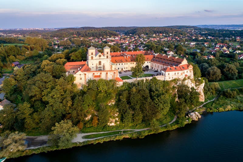 Benedictine monastery on the rocky cliff in Tyniec near Cracow, Poland, and Vistula River. Aerial view at sunset. Benedictine monastery on the rocky cliff in Tyniec near Cracow, Poland, and Vistula River. Aerial view at sunset