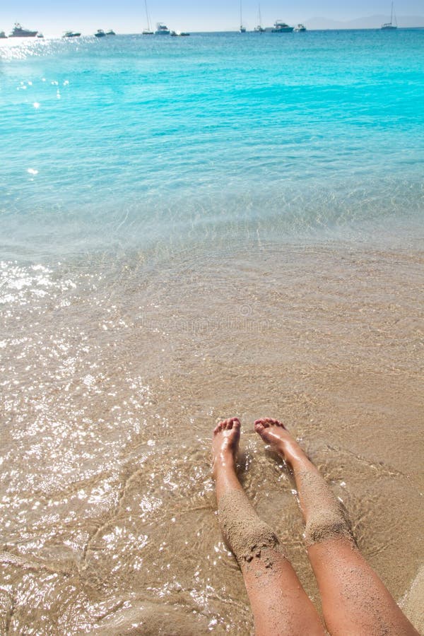 Children girl legs in beach sand shore at summer vacation. Children girl legs in beach sand shore at summer vacation