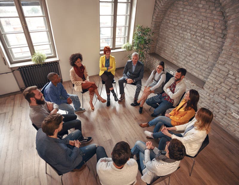 Group of business people sitting at circle in board room and discussing. Group of business people sitting at circle in board room and discussing