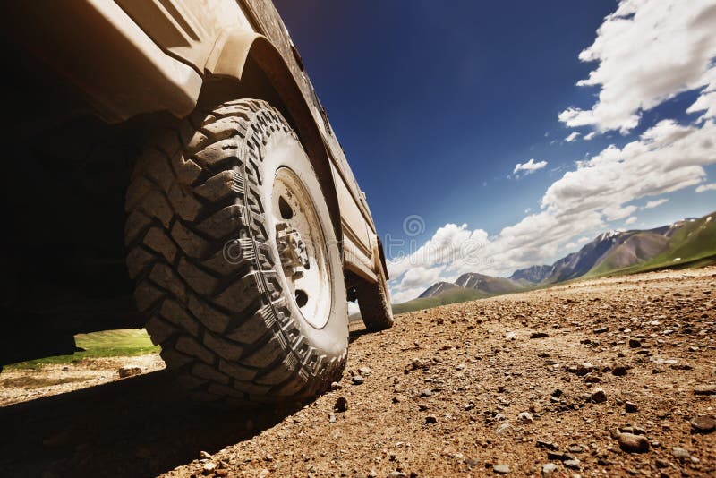 Большое offroad колесо автомобиля на проселочной дороге стоковое фото rf Большое offroad колесо автомобиля на проселочной дороге стоковое фото rf