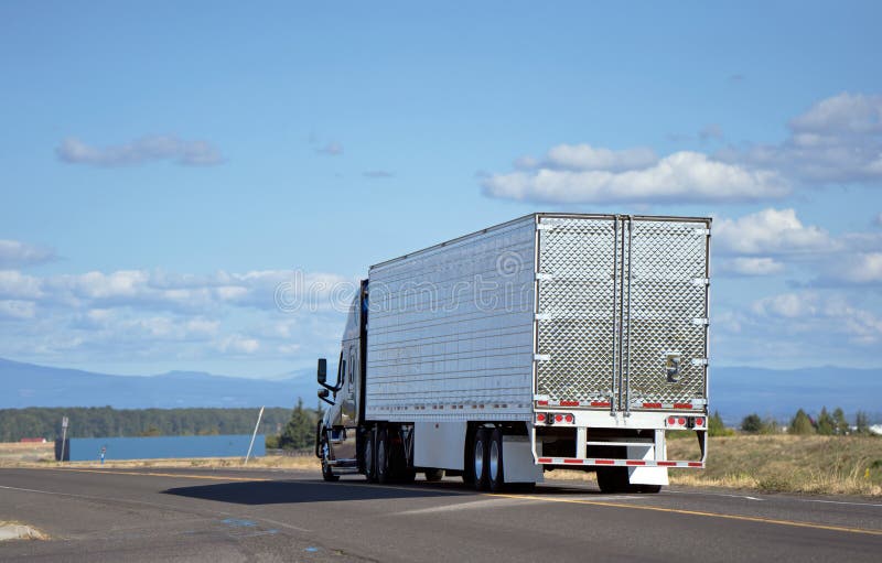 Большая полу-тележка снаряжения при reefer трейлер semi транспортируя груз o стоковое изображение Большая полу-тележка снаряжения при reefer трейлер semi транспортируя груз o стоковое изображение