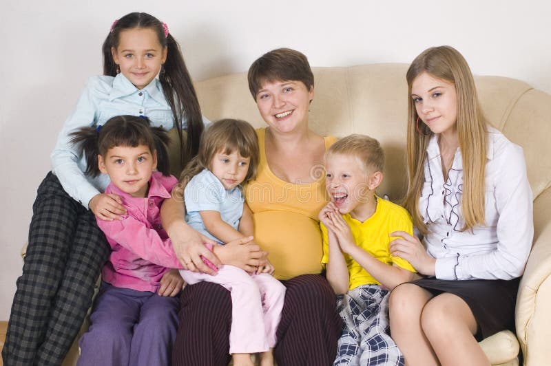 The pregnant woman with five children of different age. The pregnant woman with five children of different age