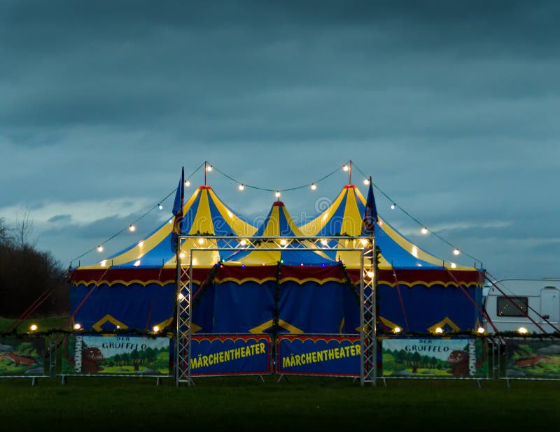 A big top of a circus lightened in the evening, ready for the performance. A big top of a circus lightened in the evening, ready for the performance