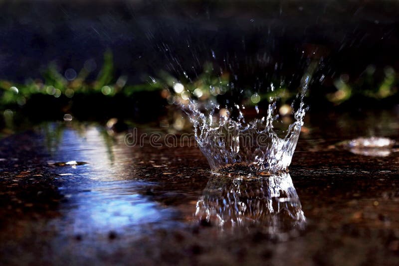 A large drop of rain hits the ground. A large drop of rain hits the ground.