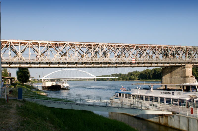 Pier cruise ship under an old bridge with Apollo Bridge in the background. Pier cruise ship under an old bridge with Apollo Bridge in the background