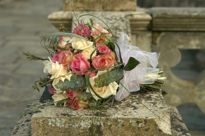 Pink and cream roses in a bridal bouquet. Pink and cream roses in a bridal bouquet