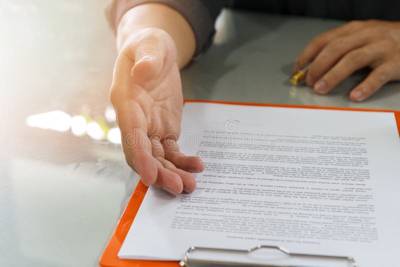 Businessman offering contract paper to his business partner for sign contract. Businessman offering contract paper to his business partner for sign contract