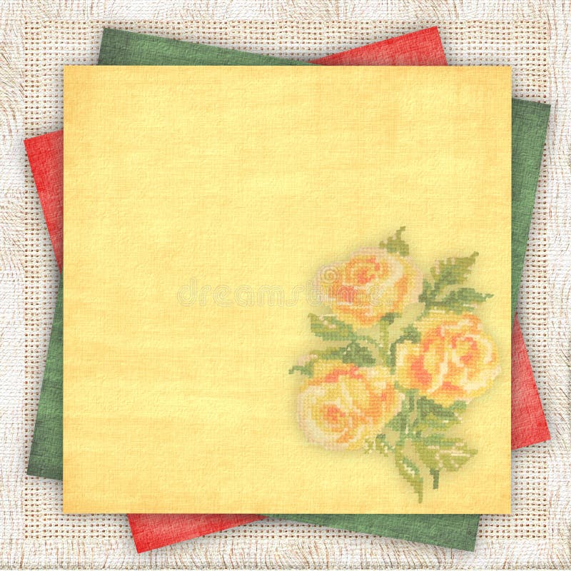 Linen fabric background with a multi-coloured paper and with the embroidered yellow roses. Linen fabric background with a multi-coloured paper and with the embroidered yellow roses