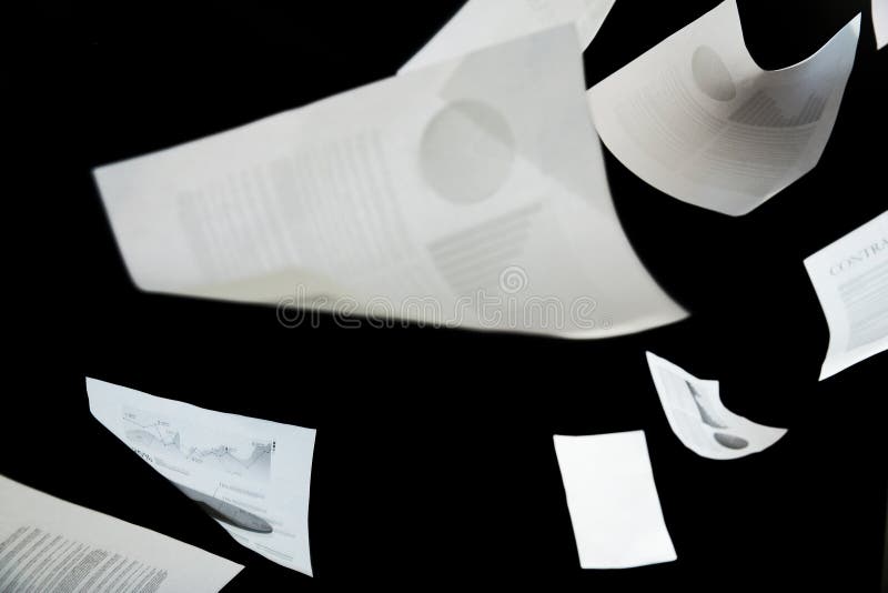 Securities, documents, finances and statistics concept - business papers falling down over black background. Securities, documents, finances and statistics concept - business papers falling down over black background