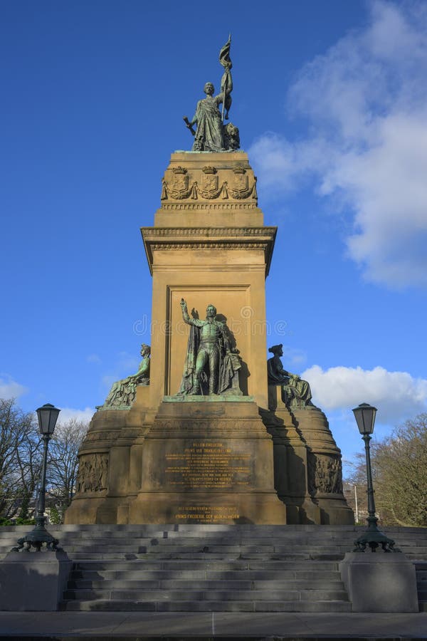 Plein 1813 is home to the monument commemorating the victory over Napoleon. The monument was revealed on 17 November 1869 by Prins Frederik of the Netherlands. It symbolizes the end of the French era in the Netherlands and the foundation in 1813 of the Sovereign Principality of the United Netherlands, the predecessor of the current Kingdom of the Netherlands. The base holds four statues and a statue group. In addition, large black letters read the name Eben-Ha�zer, referring to the victory of the Israelites over the Philistines in the Biblical book of 1 Samuel. On top of the monument stands the triumphant Dutch Virgin. The city side features King William I as he swears the constitutional oath. The Javastraat side features the triumvirate of 1813 who prepared the return of Van Orange: Gijsbert Karel van Hogendorp, Frans Adam van der Duyn van Maasdam, and Leopold van Limburg Stirum. Female figures are positioned on both sides, personifying Religion and History. Plein 1813 is home to the monument commemorating the victory over Napoleon. The monument was revealed on 17 November 1869 by Prins Frederik of the Netherlands. It symbolizes the end of the French era in the Netherlands and the foundation in 1813 of the Sovereign Principality of the United Netherlands, the predecessor of the current Kingdom of the Netherlands. The base holds four statues and a statue group. In addition, large black letters read the name Eben-Ha�zer, referring to the victory of the Israelites over the Philistines in the Biblical book of 1 Samuel. On top of the monument stands the triumphant Dutch Virgin. The city side features King William I as he swears the constitutional oath. The Javastraat side features the triumvirate of 1813 who prepared the return of Van Orange: Gijsbert Karel van Hogendorp, Frans Adam van der Duyn van Maasdam, and Leopold van Limburg Stirum. Female figures are positioned on both sides, personifying Religion and History.