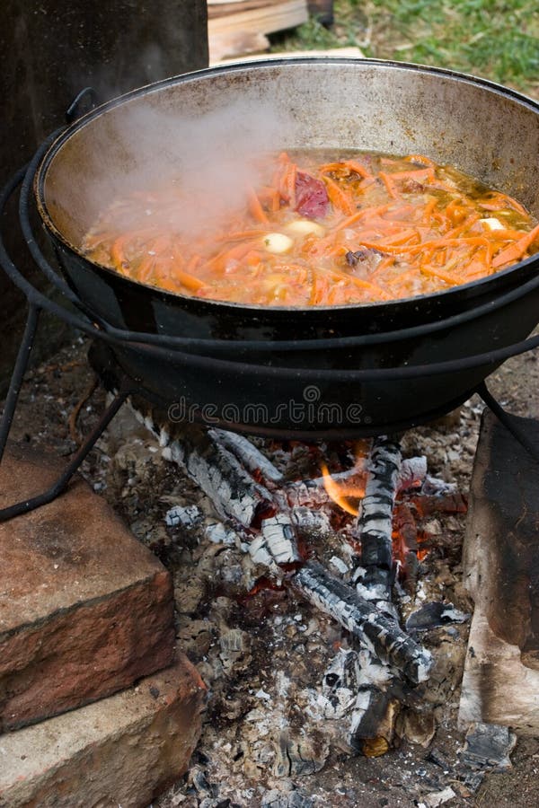 Cooking the traditional Uzbec pilaf in cauldron on fire. Cooking the traditional Uzbec pilaf in cauldron on fire