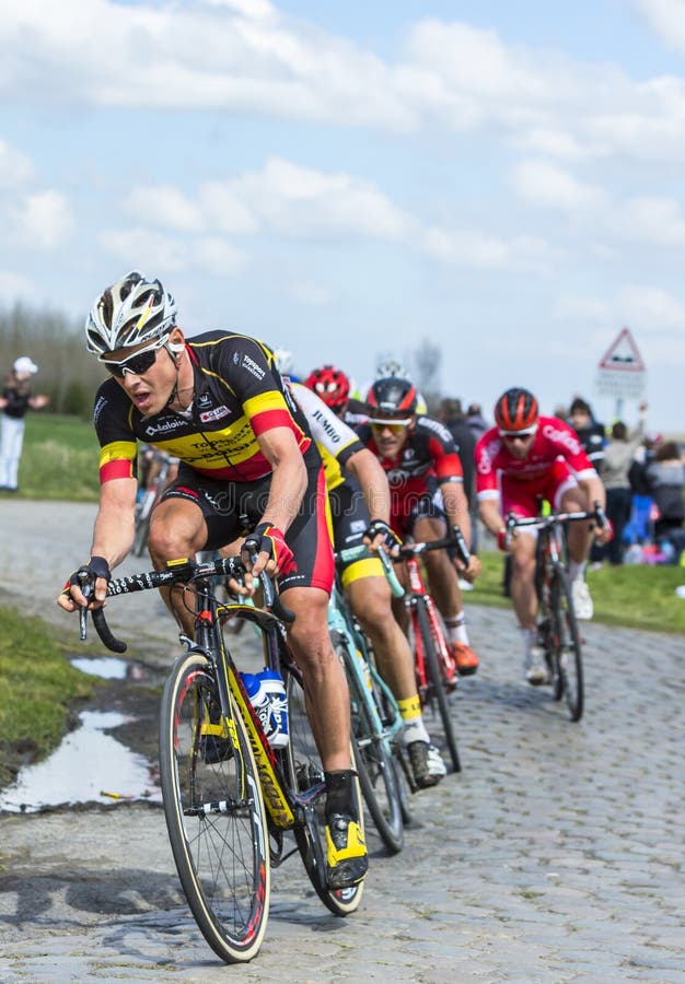 Hornaing ,France - April 10,2016: The Belgian cyclist Preben Van Hecke of Direct Energie Team riding in the peloton on a paved road in Hornaing, France during Paris Roubaix on 10 April 2016. Hornaing ,France - April 10,2016: The Belgian cyclist Preben Van Hecke of Direct Energie Team riding in the peloton on a paved road in Hornaing, France during Paris Roubaix on 10 April 2016.