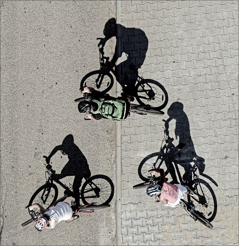 Three cyclists with the shadows. Three cyclists with the shadows