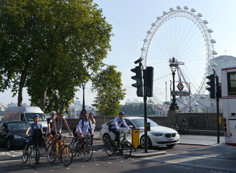 Cyclists in london traffic, with the London Eye in the background. Cyclists in london traffic, with the London Eye in the background