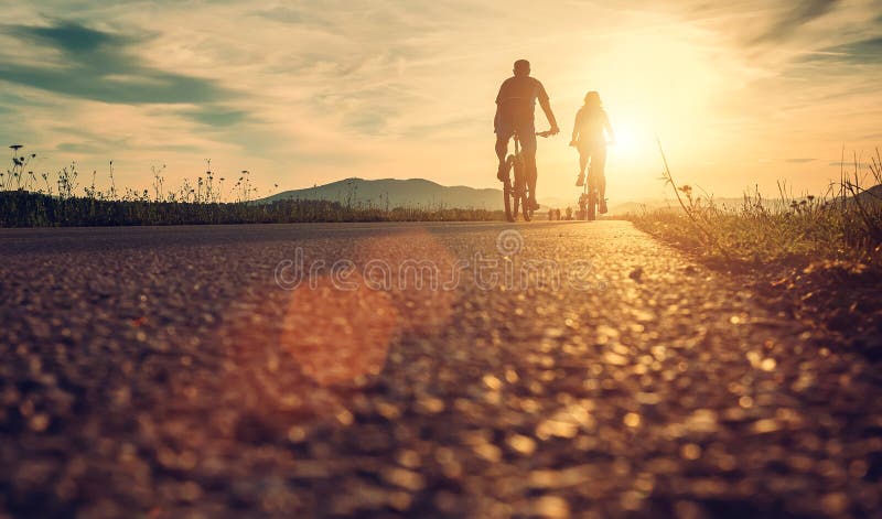 Cyclists are on the sunset road. Cyclists are on the sunset road