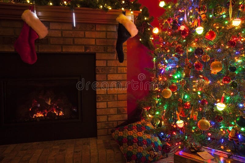 Christmas fireplace with stockings and Christmas tree and gifts. Christmas fireplace with stockings and Christmas tree and gifts.