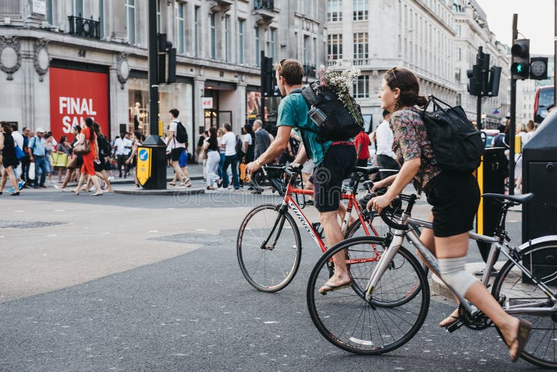 Cyclists on Oxford Street near entrance to Oxford Circus tube station, the busiest rapid-transit station in the United Kingdom. Cyclists on Oxford Street near entrance to Oxford Circus tube station, the busiest rapid-transit station in the United Kingdom.