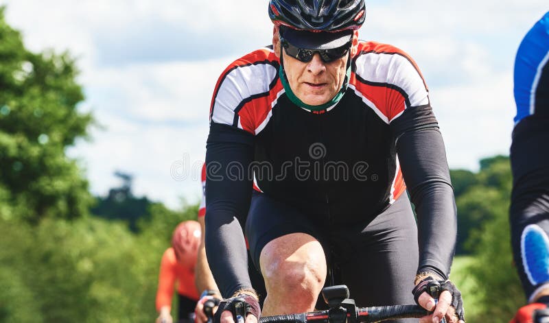 Cyclists racing on country roads on a sunny day in the UK. Cyclists racing on country roads on a sunny day in the UK.