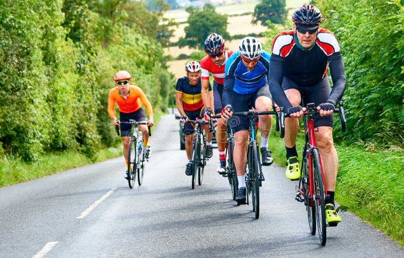 Cyclists racing on country roads on a sunny day in the UK. Cyclists racing on country roads on a sunny day in the UK.