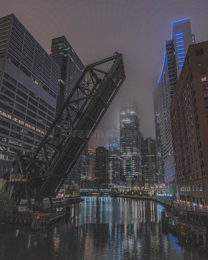 A vertical shot of the Kinzie Street railroad bridge locked in the raised position at night. A vertical shot of the Kinzie Street railroad bridge locked in the raised position at night