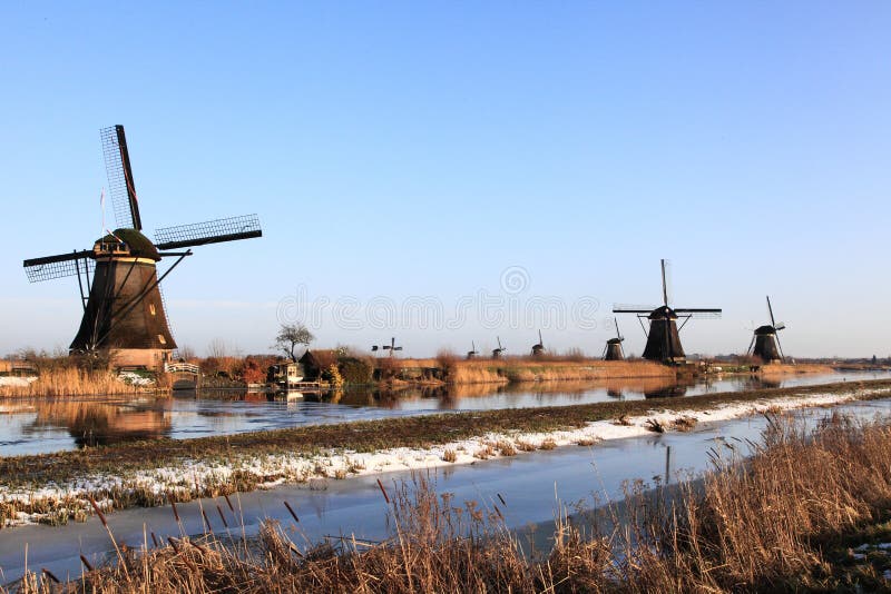 Windwills in the winter on a frozen canal at Kinderdijk, Holland. Windwills in the winter on a frozen canal at Kinderdijk, Holland