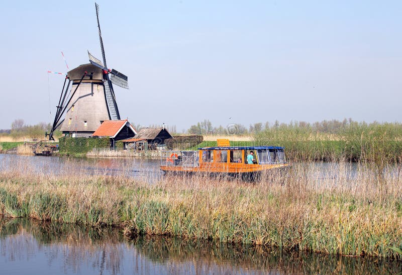 KINDERDIJK, NETHERLANDS - APRIL 1: Windmills at open air musem at Kinderdijk on April 1, 2014 in Kinderdijk. KINDERDIJK, NETHERLANDS - APRIL 1: Windmills at open air musem at Kinderdijk on April 1, 2014 in Kinderdijk