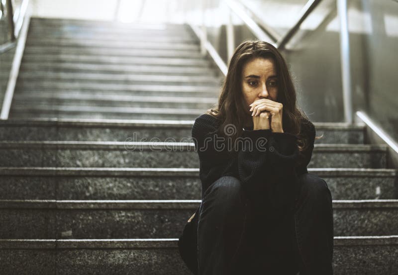 Adult Woman Sitting Look Worried on The Stairway. Adult Woman Sitting Look Worried on The Stairway