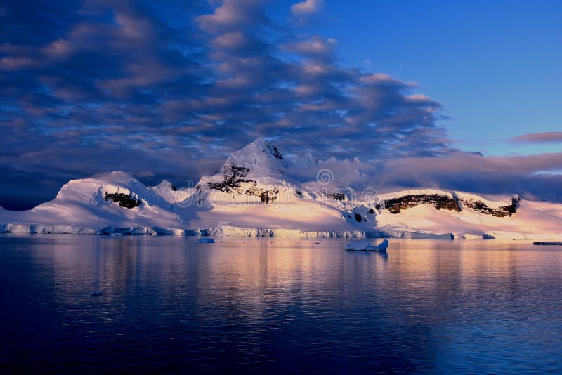 Views of the entrance to the Lemaire Channel in Antarctica, with sunset illuminating mountains. Views of the entrance to the Lemaire Channel in Antarctica, with sunset illuminating mountains