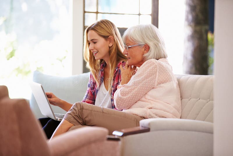 Adult Granddaughter Helping Grandmother With Computer. Adult Granddaughter Helping Grandmother With Computer